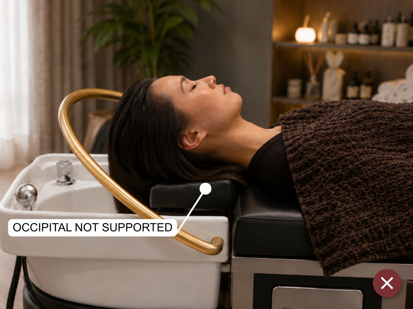 Side view of the same client positioned incorrectly, illustrating a setup mistake: chin lifted, neck extended back toward the basin edge instead of supported by the headrest curve.